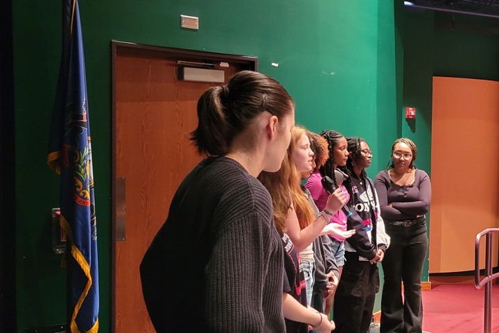 Current student volunteers speak share their experience with their peers at a CAPA assembly.
