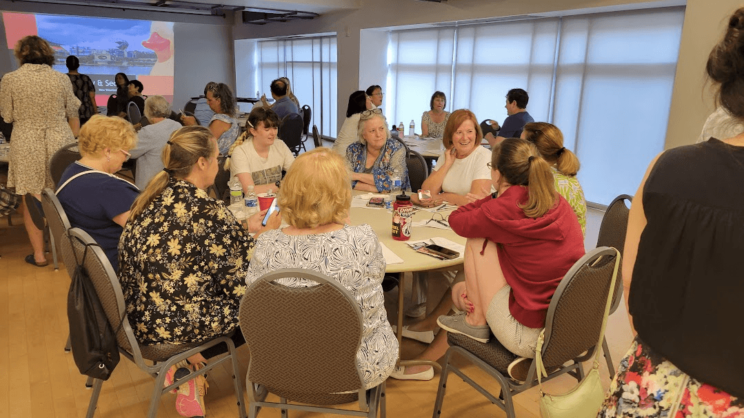 a group of new volunteers sit around a table