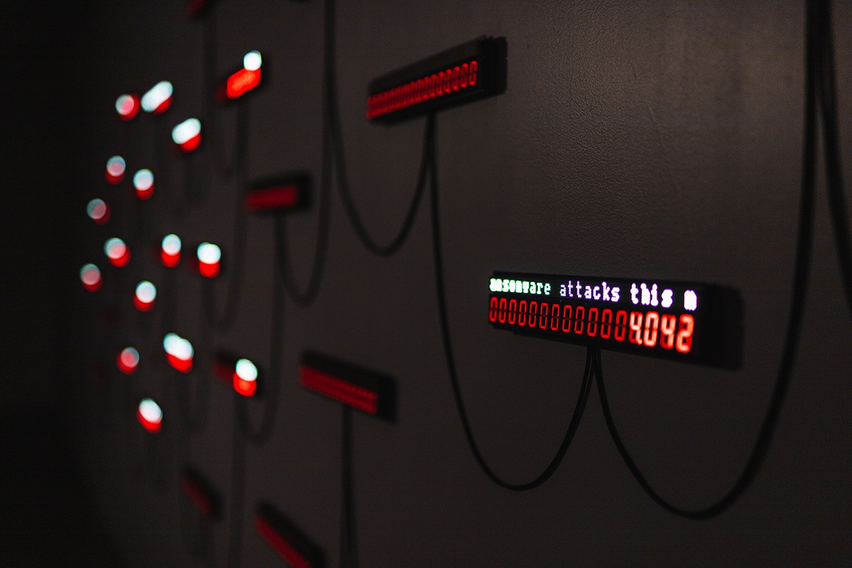 a closeup of a small LED panel hanging on a wall. the panel says '...ransomware attacks this... 4042'