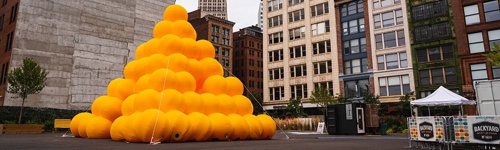a large inflatable pyramid made of yellow spheres