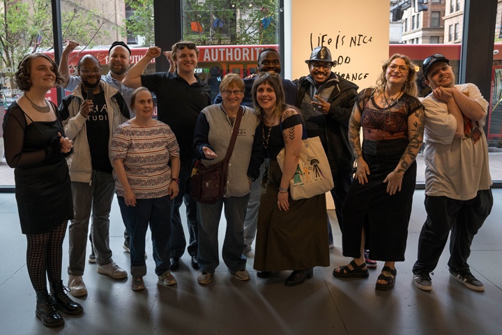 Group photo of artists posing in open gallery space.