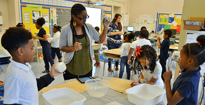 teaching artist and students participate in interactive activity