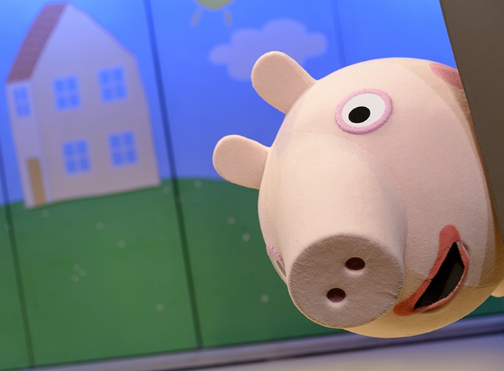Peppa Pig peers out at the audience