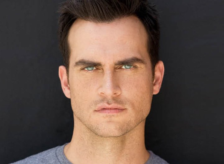 headshot of Cheyenne Jackson; he has dark hair and piercing blue eyes