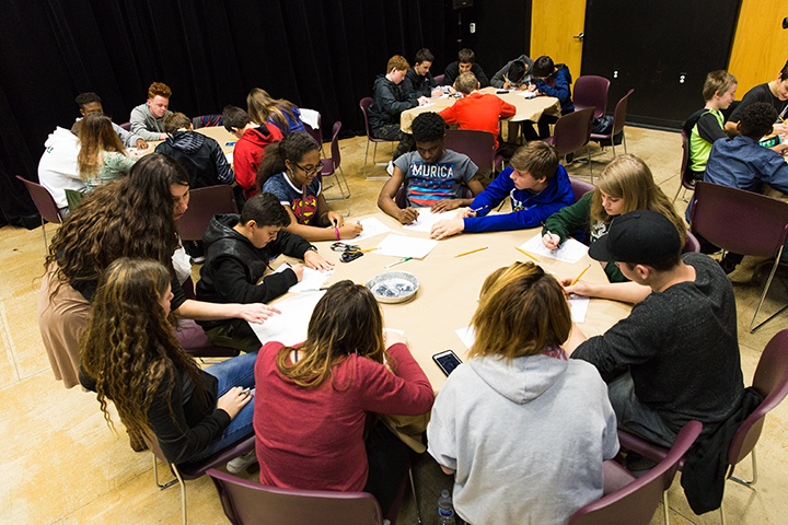 a table of female students participate in arts workshop