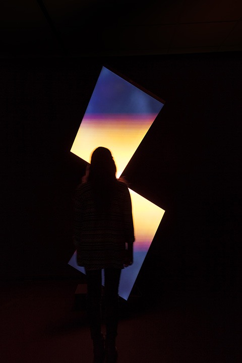 a patron examines a light sculpture part of the upcoming wood street galleries exhibit