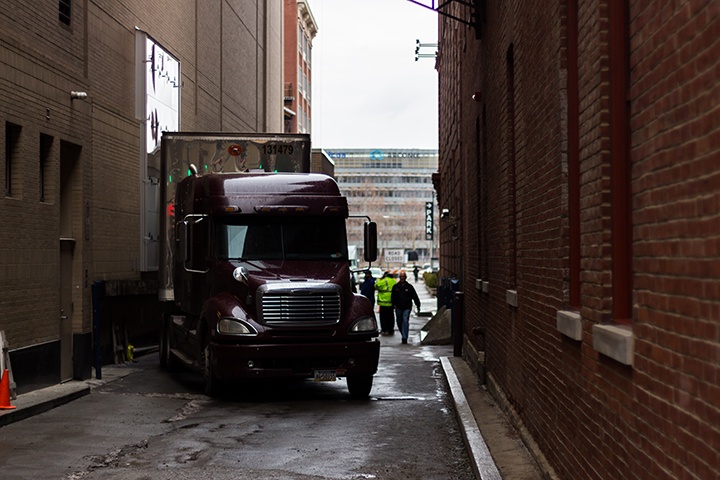 a semi truck unloads pieces of the wicked set