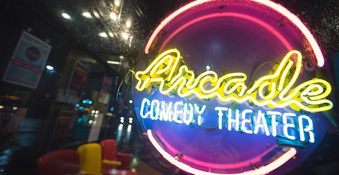 Arcade Comedy Theater's logo depicted on a neon sign