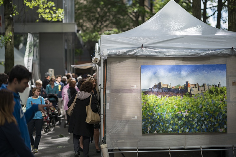 white tent with artwork on display