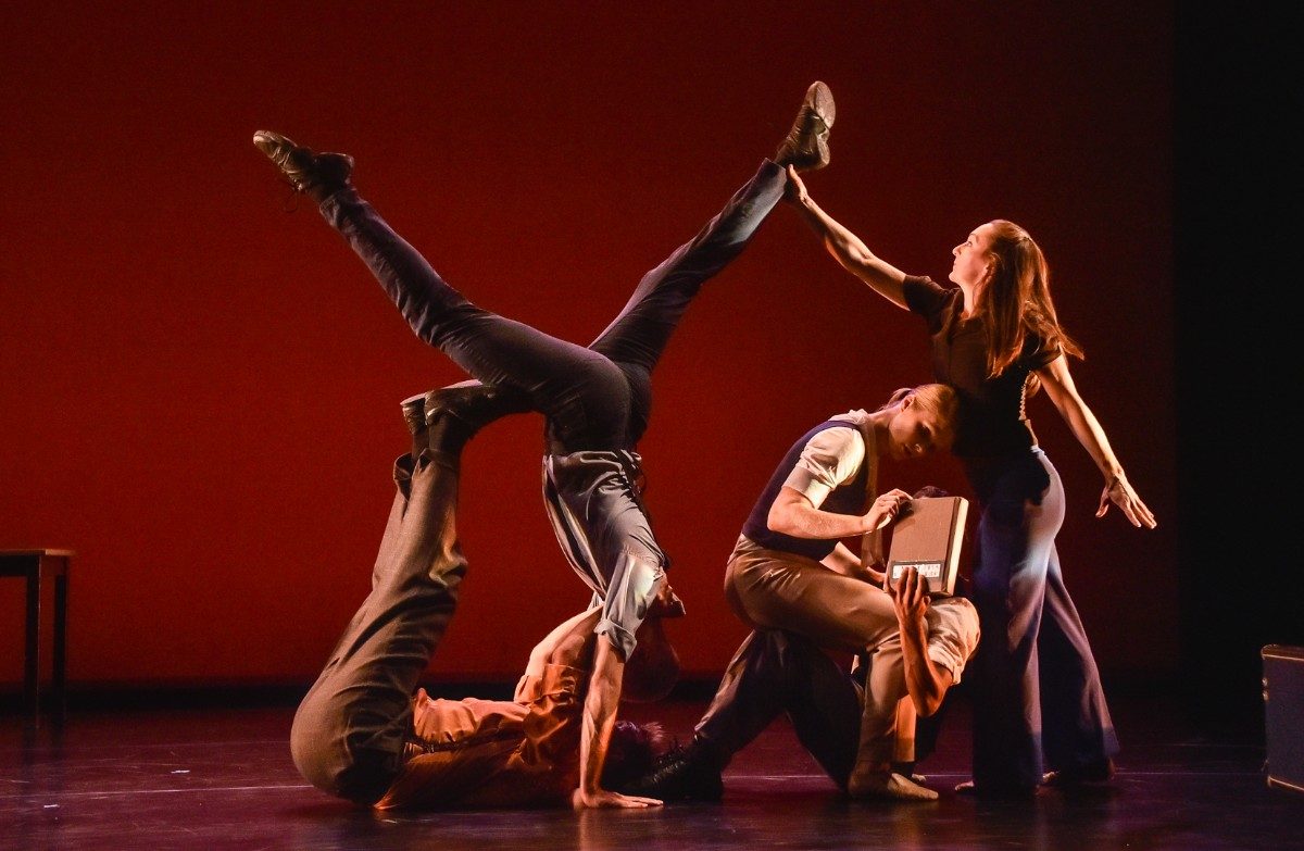 five dancers holding each other in formation
