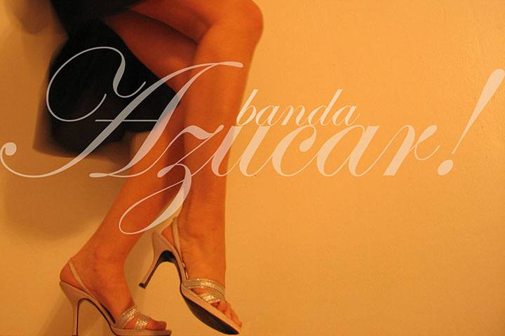 a promotional image for Azucar showing a woman's legs in mid dance move