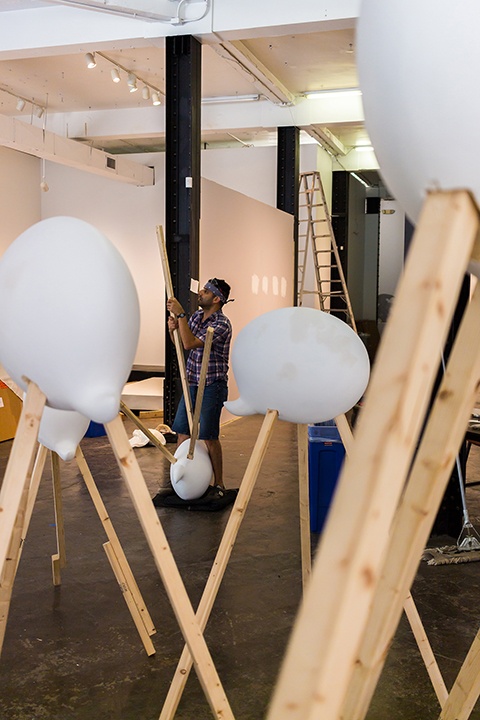 An artist assembles his exhibit as part of Identity Play