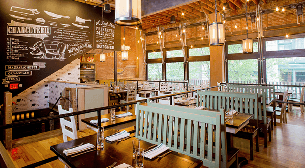 cozy restaurant interior with bright lighting and farm tables