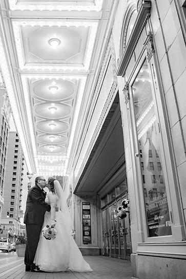 the couple poses under the benedum center's marquee lights