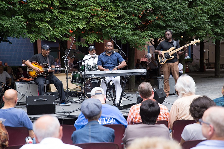 an audience watches a jazz performance outside in katz plaza