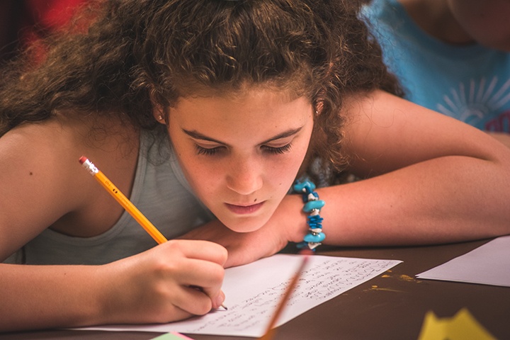 a workshop participant writes on a piece of paper