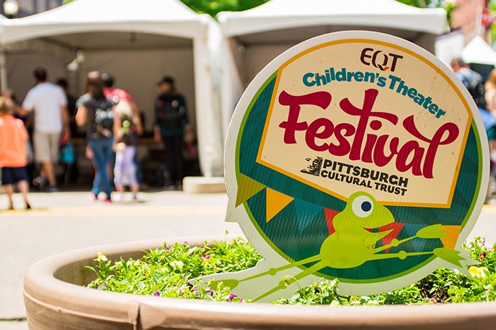 a children's festival sign in a potted plant
