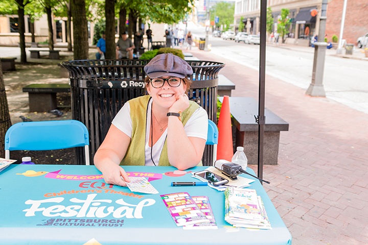 a festival guide sits at an info table