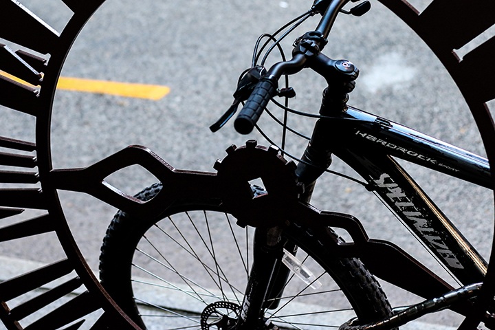 a bike locked at a downtown artist-made bike rack