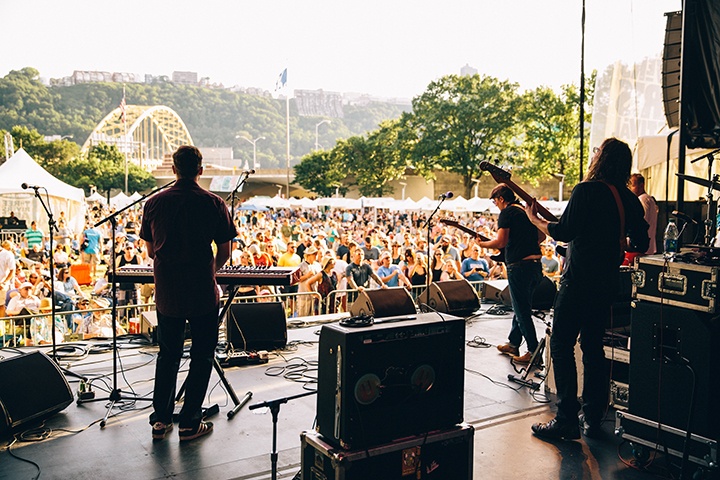 a crowd watches a concert at the three rivers arts festival in point state park