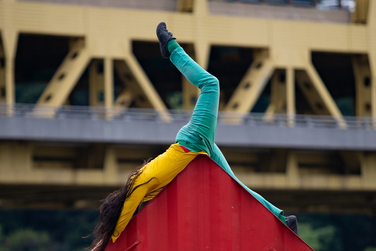 Close up shot of Satchie dancing with shipping container