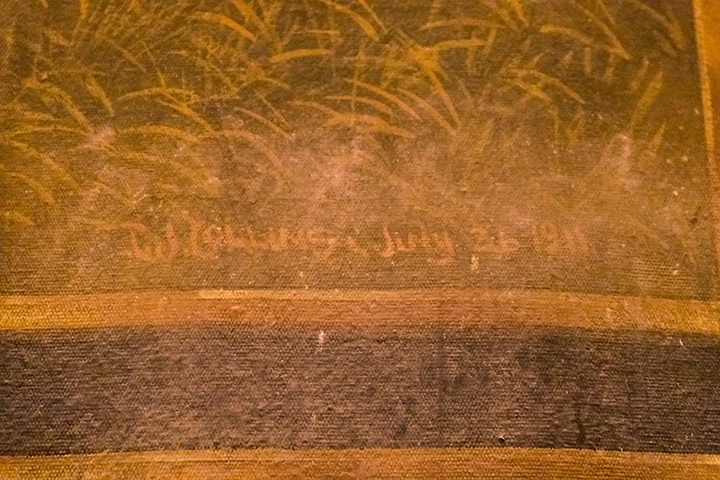 a detail shot of the dating and signature on the curtain reading 'T.J. Collins July 26 1911'