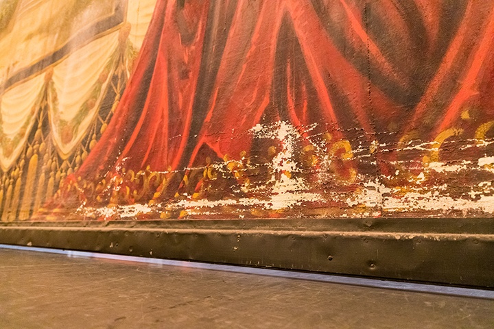a photo showing the chipping and flaking paint damage found at the bottom of the curtain