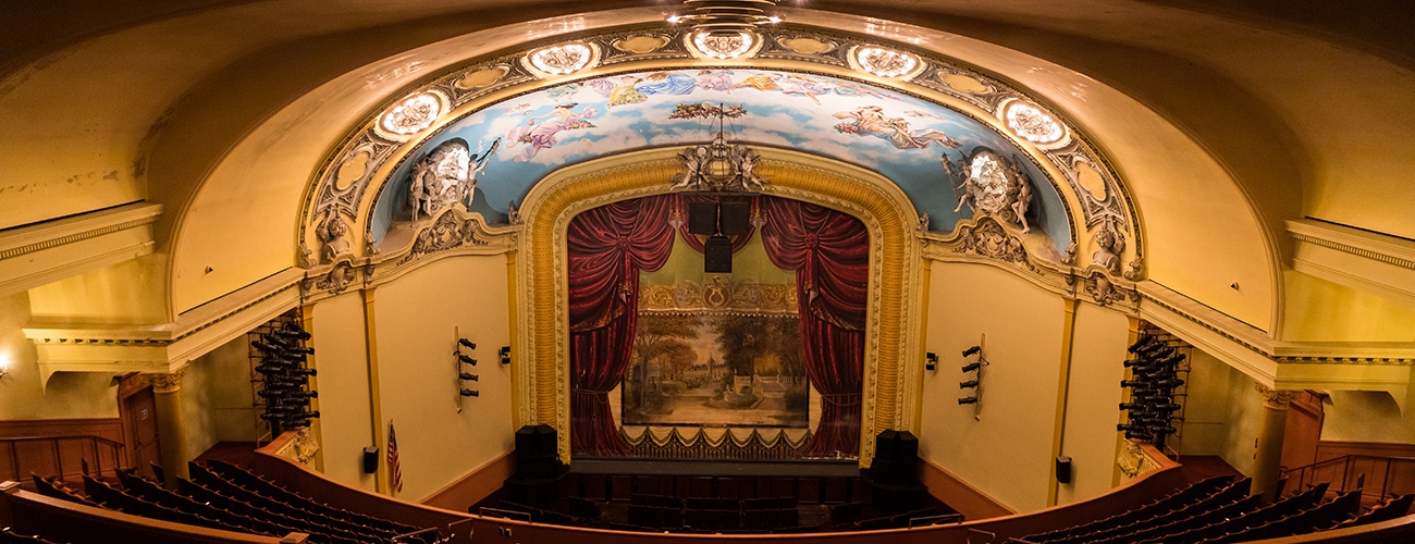 a wide shot of the byham theater auditorium, looking down on the lowered fire curtain