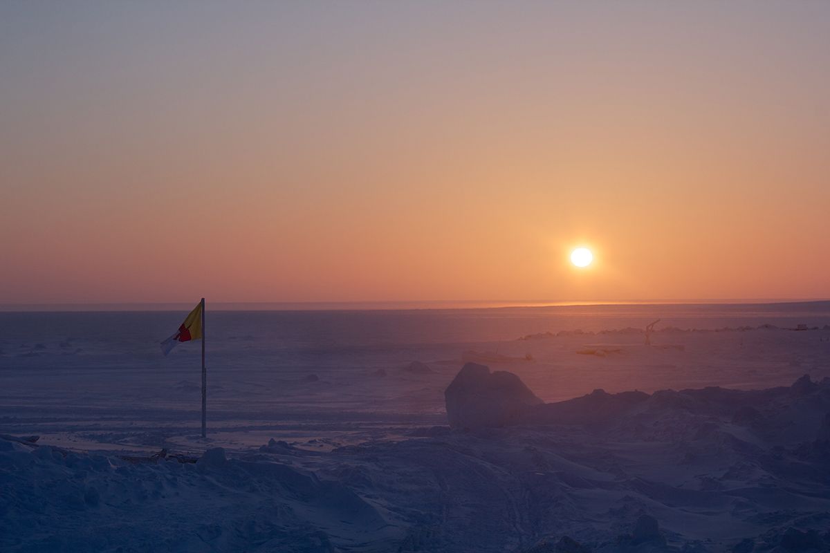 a photo of a sun setting over a large body of water