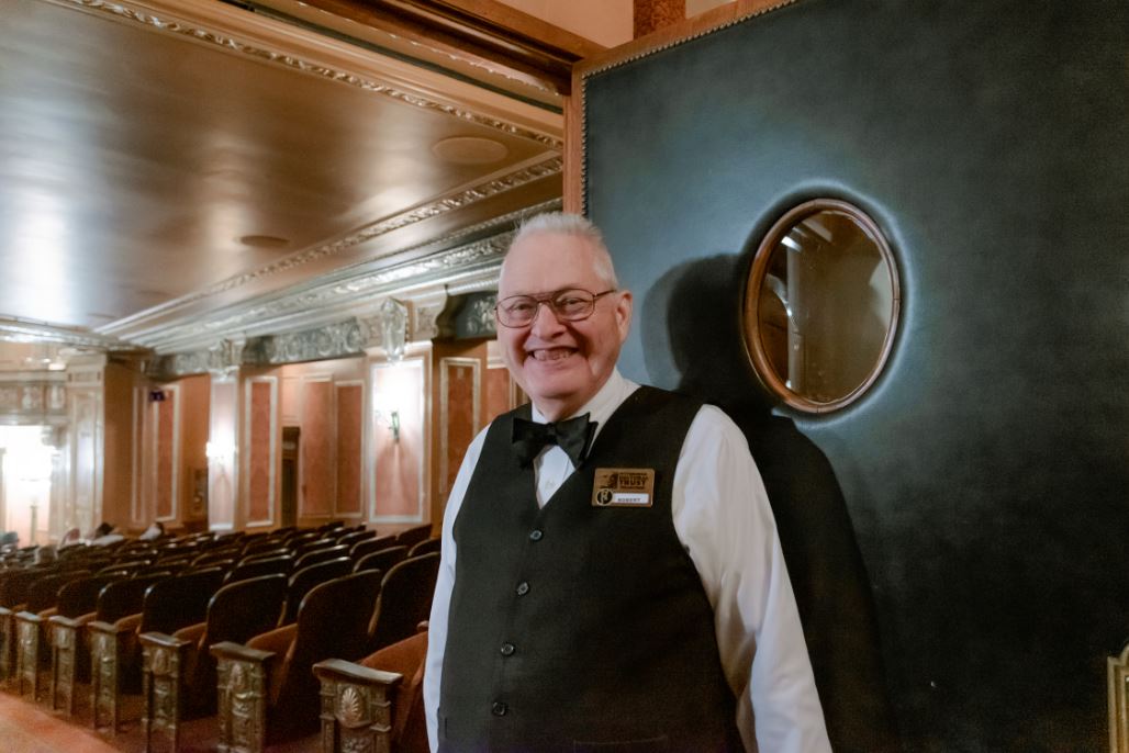 Benedum greeter smiles outside the theater doors