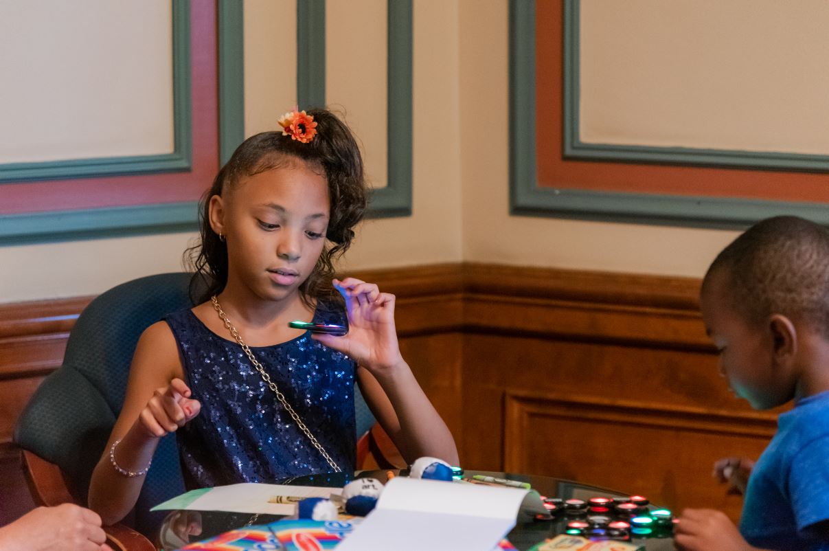 Girl playing with fidget spinner in the activity center