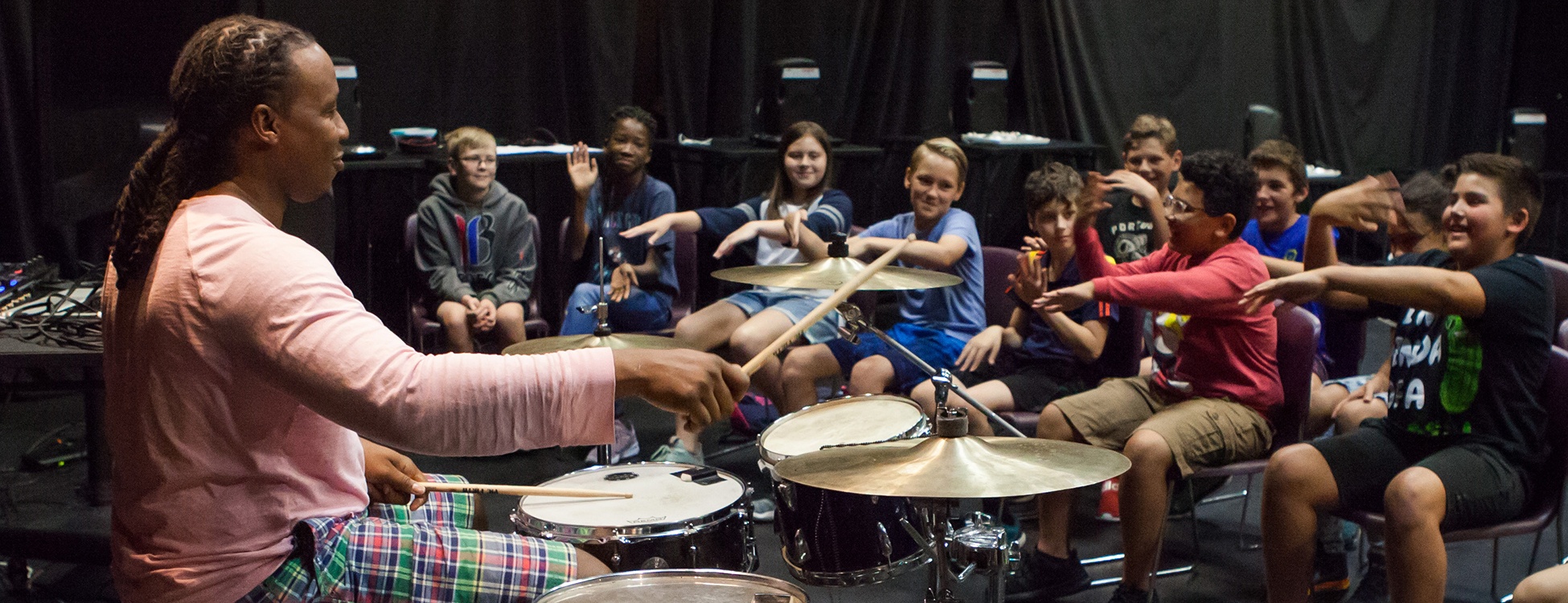 a photo of Dennis drumming at a Trust Arts Education workshop