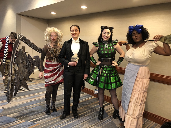 four people dressed in cosplay as broadway show characters