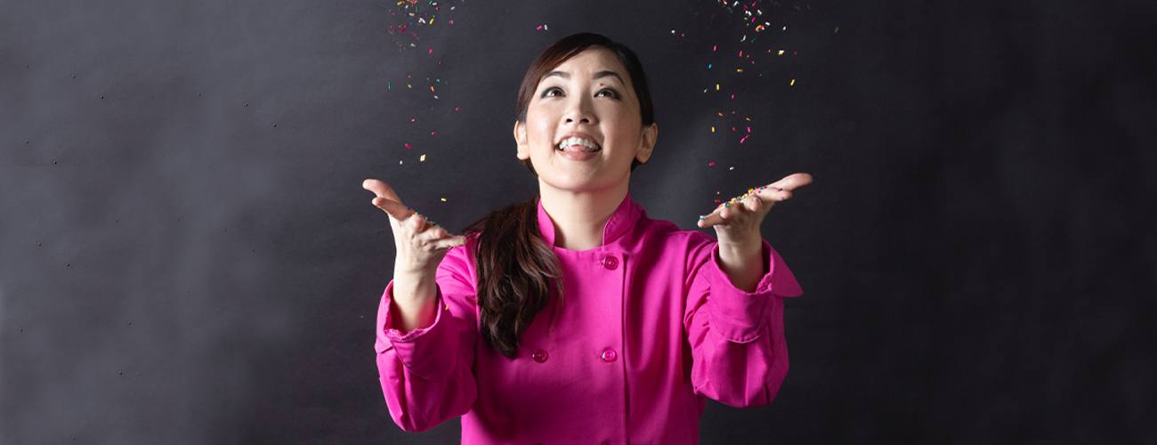 Headshot of Jasmine Cho smiling and throwing sprinkles