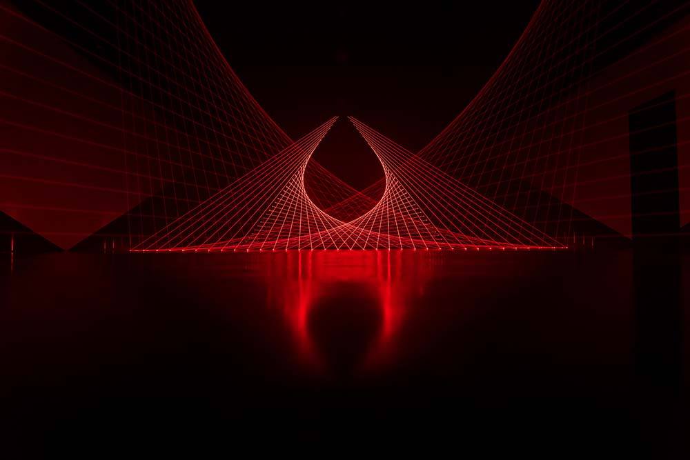  A wide view of Double Gemini, where dozens of red lasers in a dark room form a geometric pattern of curves and grids