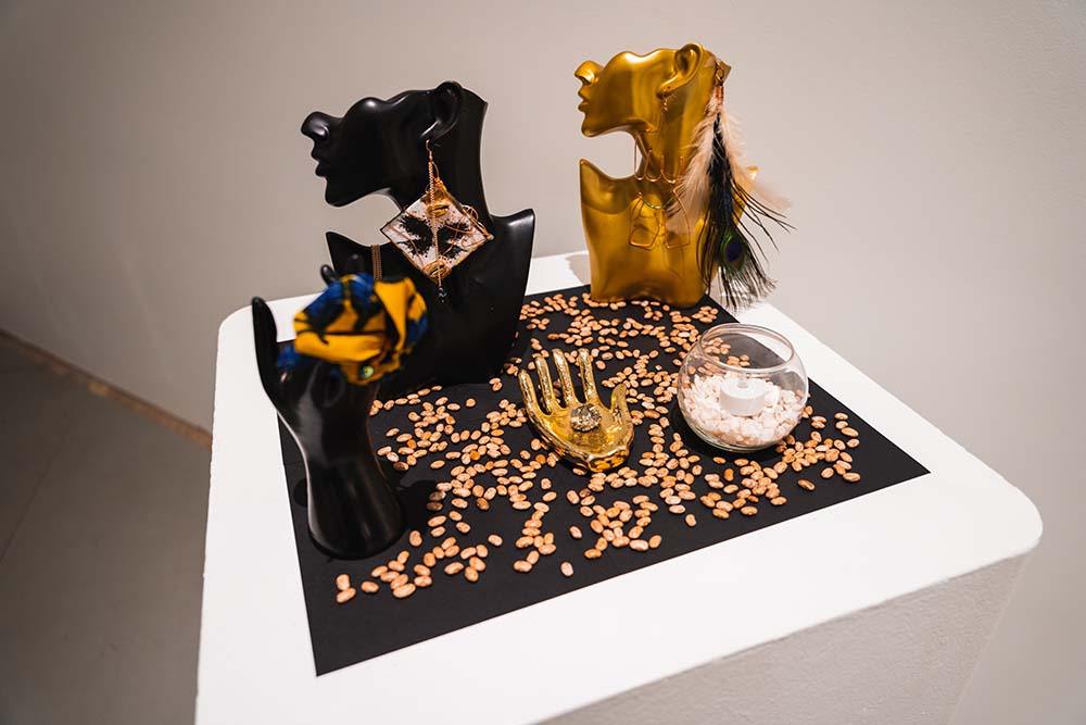 A podium that holds busts displaying various pieces of jewelry
