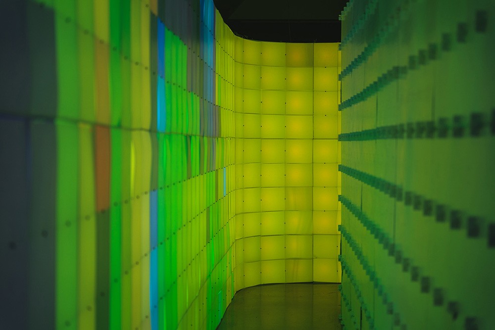 a corridor made by two walls of green and yellow light up blocks