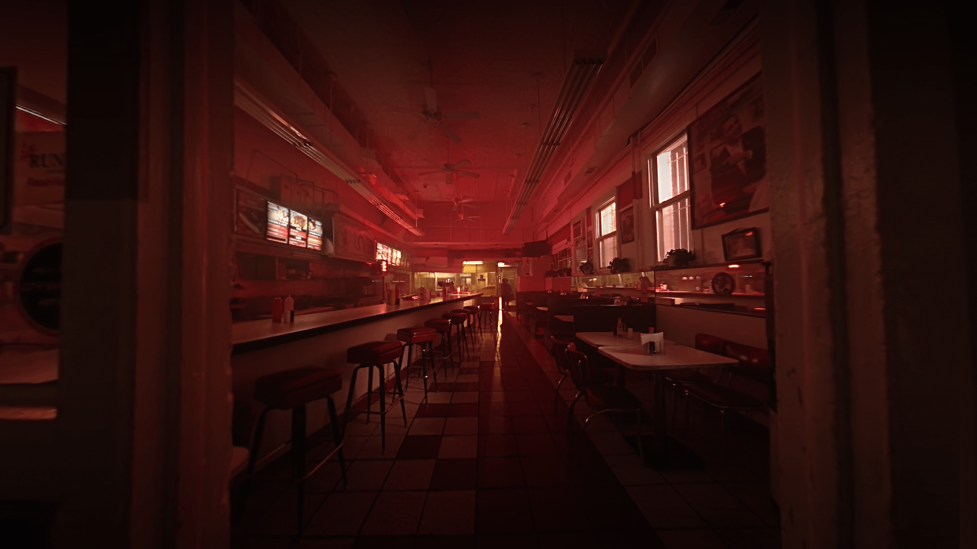 a fisheye point of view image showing a dim restaurant at night, lit up by red lighting