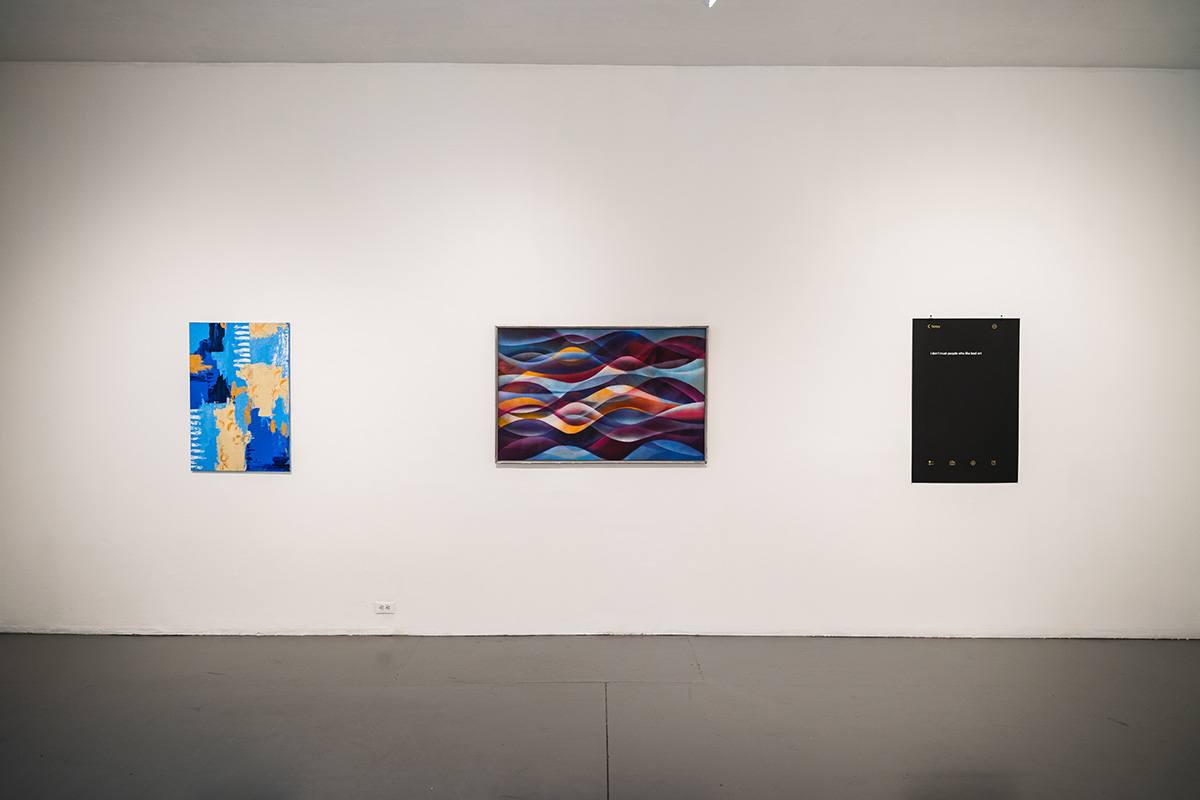 three works by different artists hang on a white gallery wall