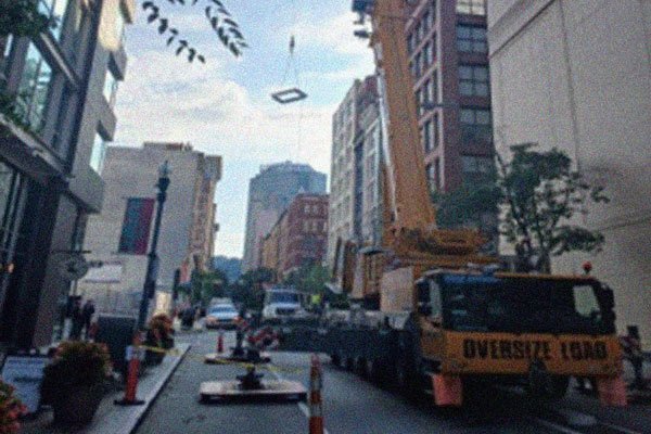 A crane hoists smoke hatches