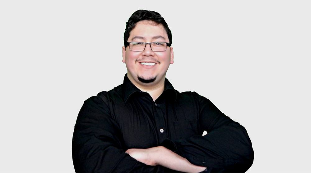 headshot of kevin araujo, a man with short black hair in a black polo shirt