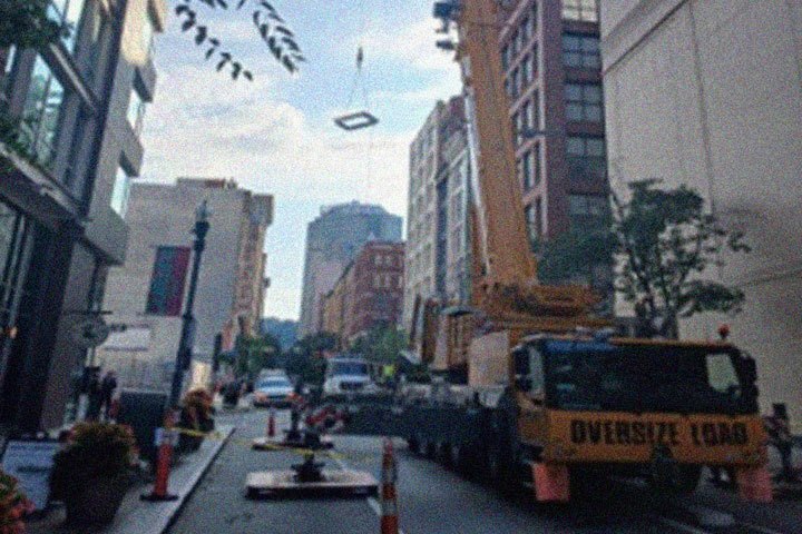 A crane hoists smoke hatches