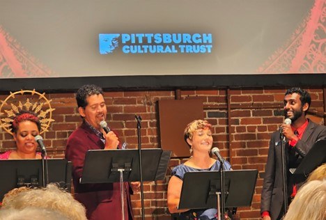  Trust staff members sing on stage at the Volunteer Appreciation Party