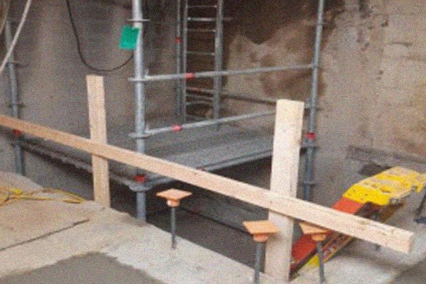 Scaffolding and concrete form the base of the new elevator.