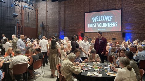  volunteers sit at tables during the Volunteer Appreciation Party