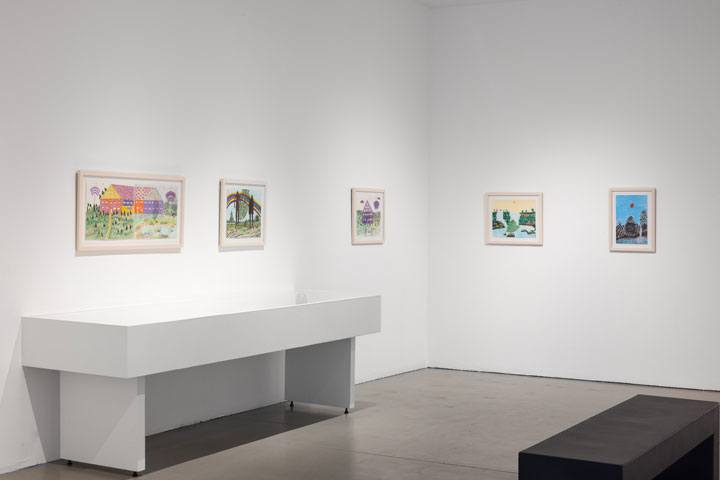 Gallery space with five relatively small and colorful drawings on the white walls.