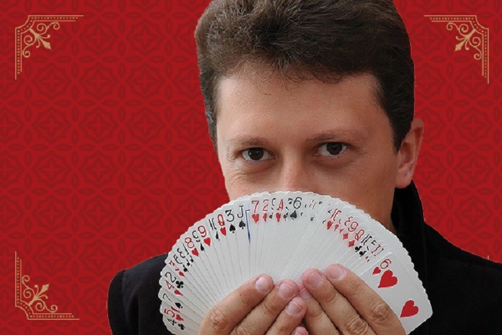 a man fanning out a deck of cards in front of his face