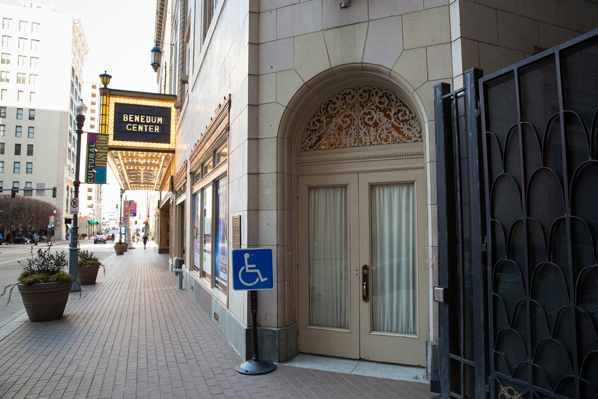 the guest services entrance at the benedum center. a blue handicapped sign stands in front of doors to the right of the main theater entrance.